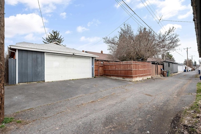 detached garage featuring fence