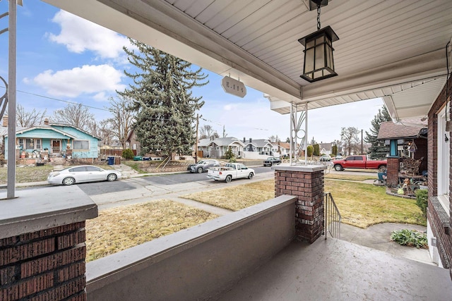 view of patio with covered porch and a residential view