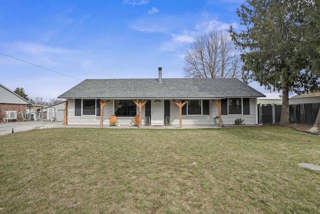 ranch-style home featuring a front lawn, fence, and covered porch