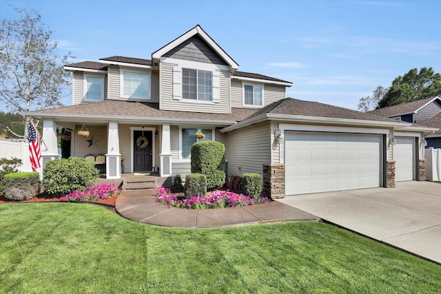 view of front facade featuring driveway, stone siding, a porch, a front yard, and an attached garage