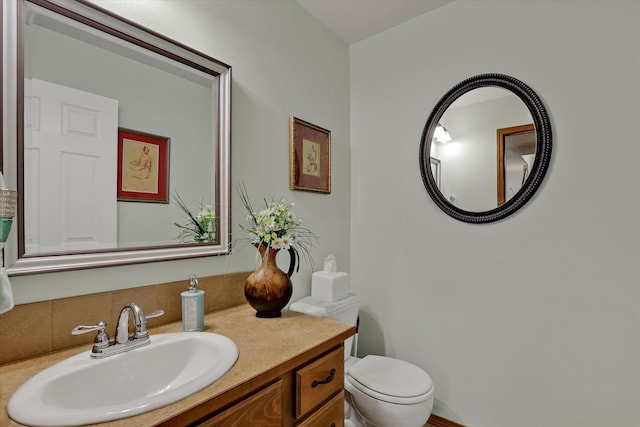 half bath featuring toilet and vanity