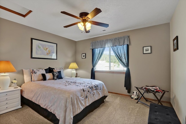 bedroom featuring light carpet, visible vents, baseboards, and a ceiling fan