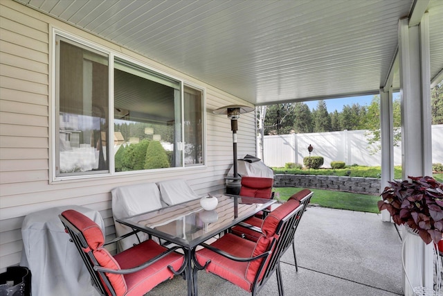 view of patio with outdoor dining space and fence