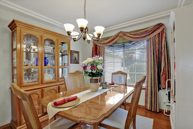 dining space with an inviting chandelier and wood finished floors