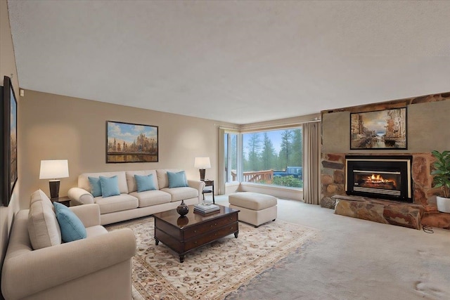 living area featuring carpet floors and a stone fireplace