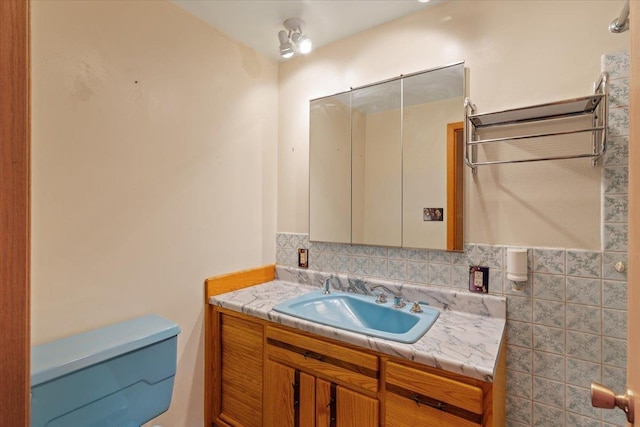 bathroom featuring toilet and vanity