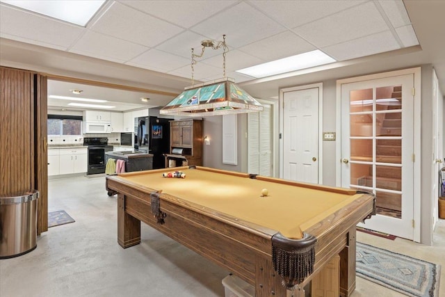 rec room with a drop ceiling, pool table, and concrete floors