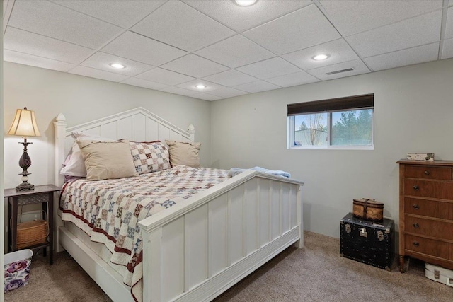 carpeted bedroom featuring recessed lighting, visible vents, and a drop ceiling