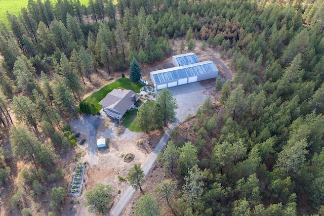 birds eye view of property featuring a view of trees