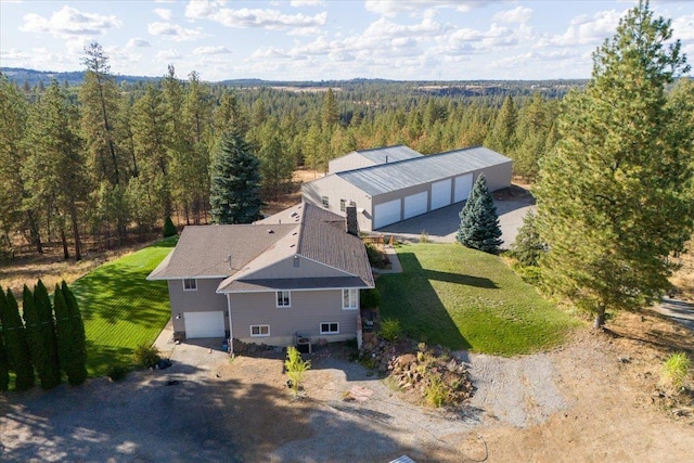 birds eye view of property with a wooded view