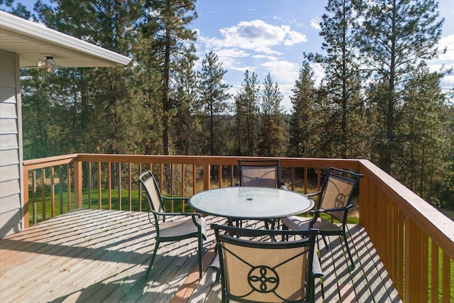 wooden terrace featuring outdoor dining area