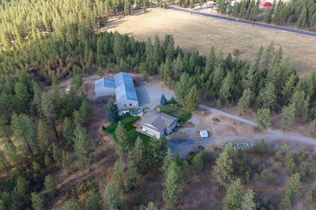 birds eye view of property with a wooded view