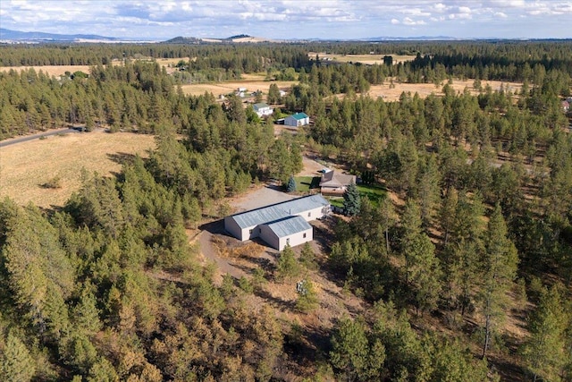 birds eye view of property featuring a view of trees