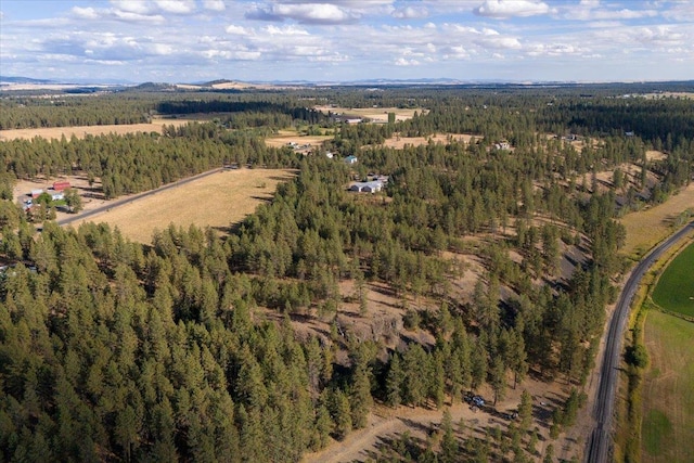 birds eye view of property with a rural view and a view of trees