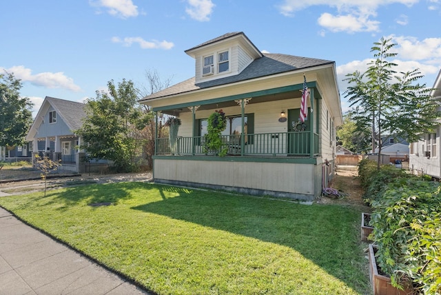 bungalow with covered porch and a front yard