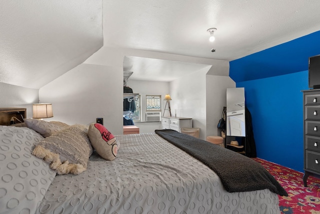 carpeted bedroom with lofted ceiling, cooling unit, and a textured ceiling