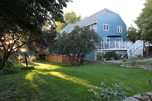 view of yard featuring a wooden deck and fence