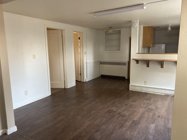 unfurnished living room with a baseboard radiator, baseboards, dark wood finished floors, and radiator heating unit