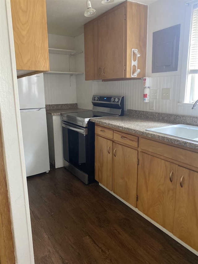 kitchen with electric range, a sink, open shelves, dark wood finished floors, and freestanding refrigerator