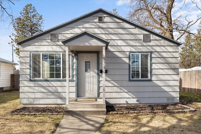 bungalow-style home with crawl space and fence