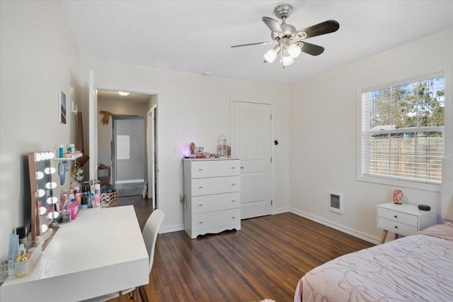 bedroom featuring ceiling fan, wood finished floors, visible vents, and baseboards