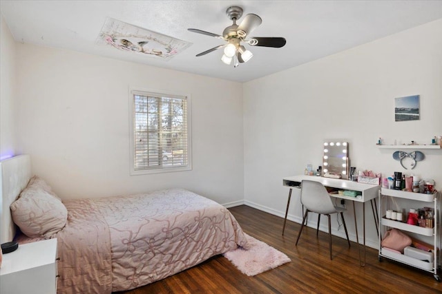 bedroom featuring baseboards and wood finished floors