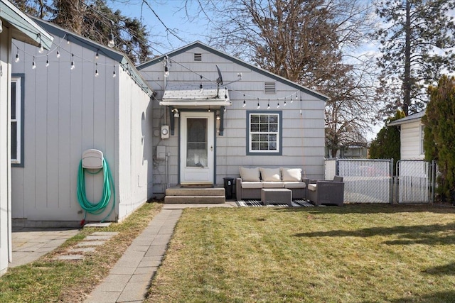 rear view of property with an outdoor living space, roof with shingles, a yard, and fence