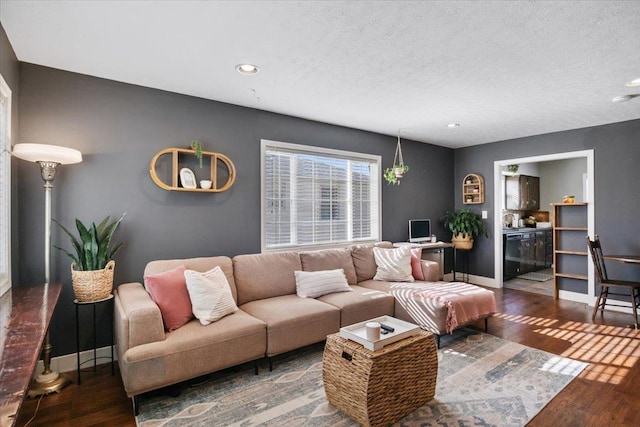 living area with recessed lighting, baseboards, a textured ceiling, and wood finished floors