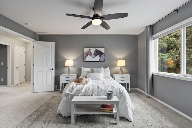 carpeted bedroom featuring visible vents, ceiling fan, and baseboards