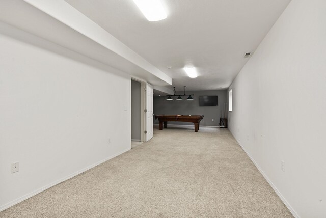 finished below grade area with visible vents, baseboards, light colored carpet, and pool table