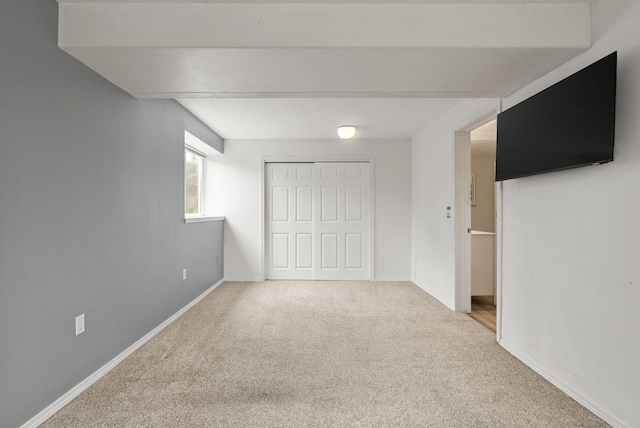 interior space featuring a closet, baseboards, and carpet floors