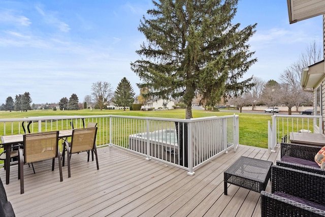 wooden terrace with a lawn and outdoor dining area