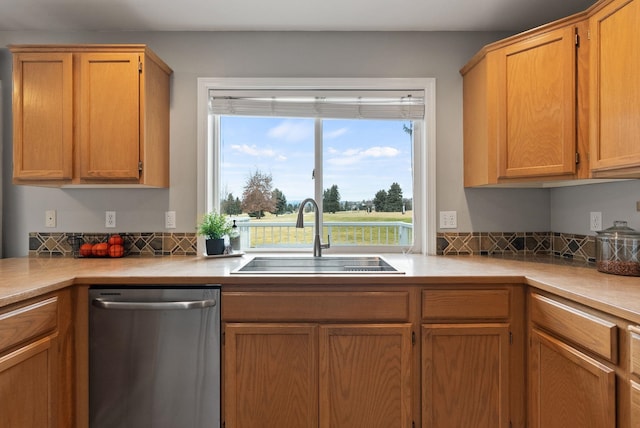 kitchen with a sink, light countertops, and stainless steel dishwasher