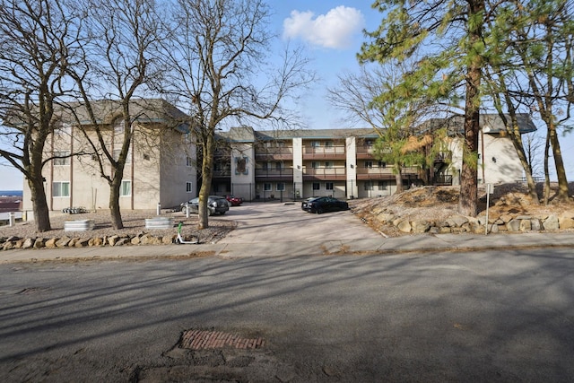 view of property featuring uncovered parking