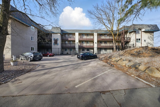 view of property featuring uncovered parking