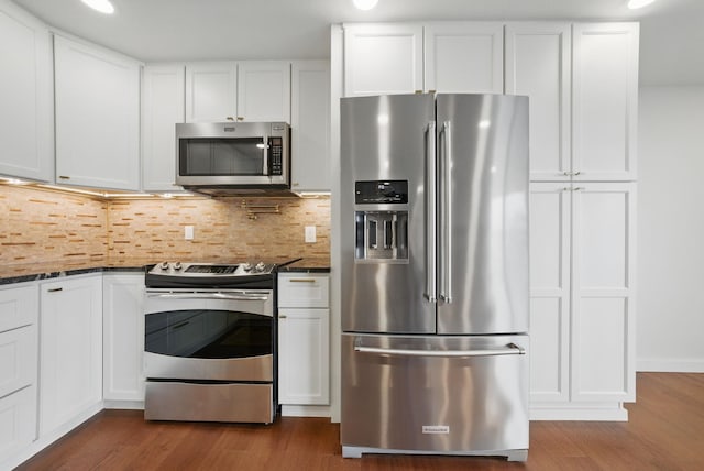 kitchen featuring appliances with stainless steel finishes, dark wood-style flooring, and white cabinetry