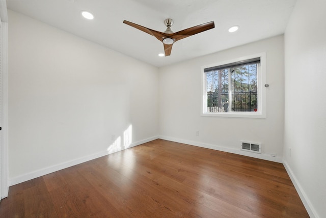 spare room featuring recessed lighting, visible vents, baseboards, and wood finished floors