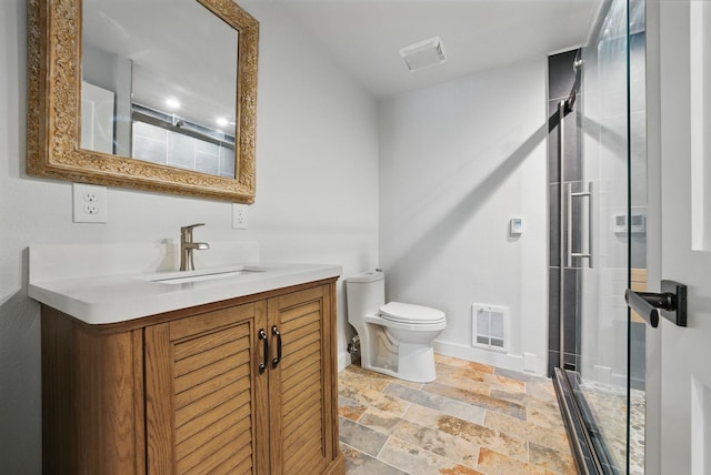 bathroom with visible vents, toilet, a stall shower, and stone finish floor