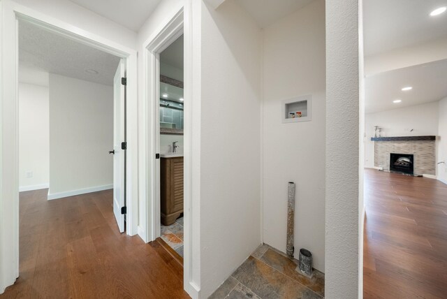 hall featuring recessed lighting, wood finished floors, and baseboards