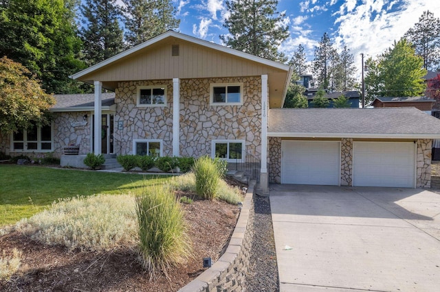 view of front of property featuring a garage, concrete driveway, a front yard, and a shingled roof