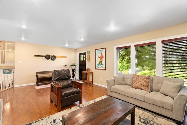 living area with recessed lighting, baseboards, and wood finished floors