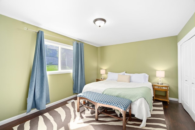 bedroom featuring a closet, baseboards, and wood finished floors