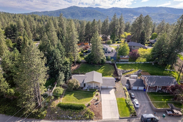 drone / aerial view with a mountain view and a wooded view