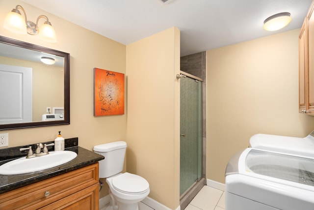 full bathroom with washer and clothes dryer, toilet, a stall shower, tile patterned floors, and vanity