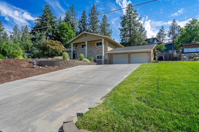 view of front of property featuring stone siding, an attached garage, concrete driveway, and a front lawn