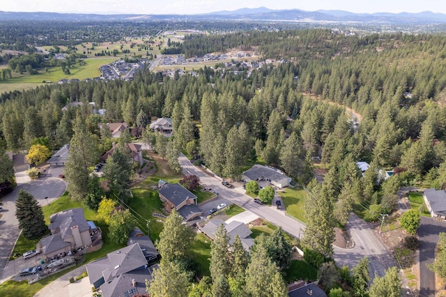 aerial view with a forest view, a mountain view, and a residential view