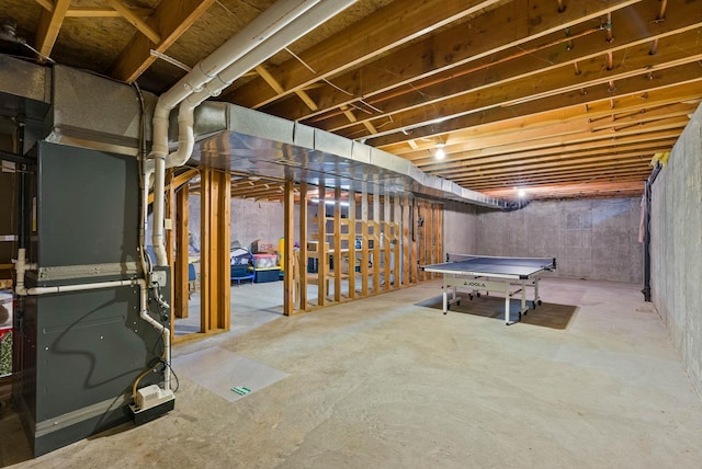 unfinished basement featuring heating unit