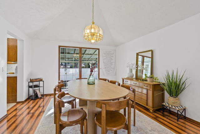 dining space featuring a wealth of natural light, dark wood-style flooring, and vaulted ceiling