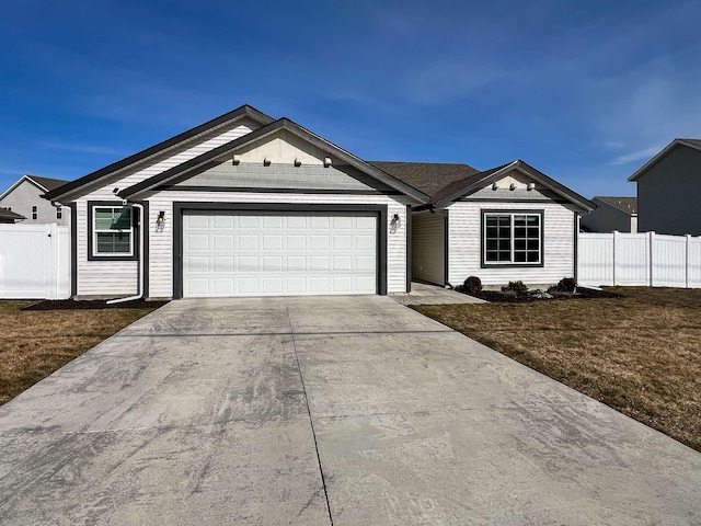 ranch-style home featuring a garage, concrete driveway, and fence