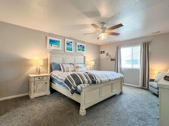 bedroom featuring visible vents, a ceiling fan, baseboards, and dark colored carpet